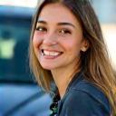 Emily Harris smiling with her car